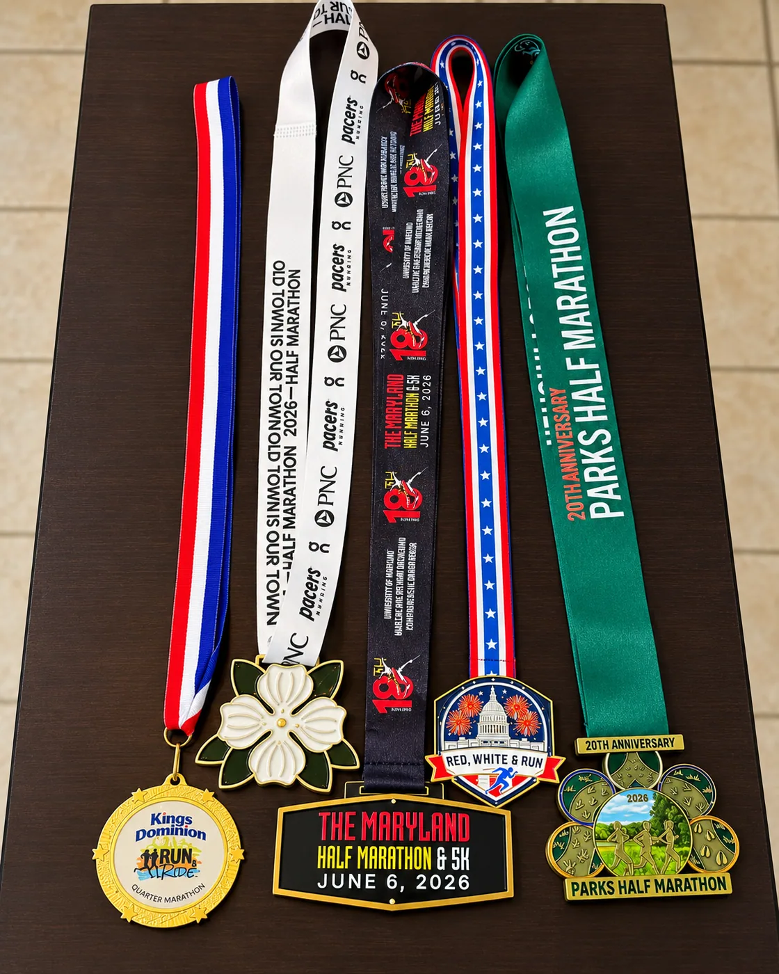 A collection of 2026 DMV-area race medals displayed on a table